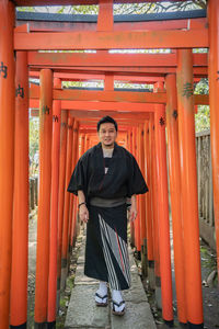 Portrait of smiling man standing outside building