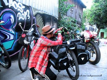 Man riding motorcycle on road in city