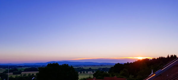 Scenic view of landscape against sky at sunset