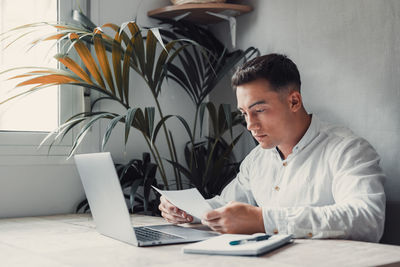 Young woman using laptop at home