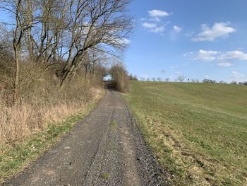 Road amidst trees on field against sky , in eichsfeld, thuringia, germany