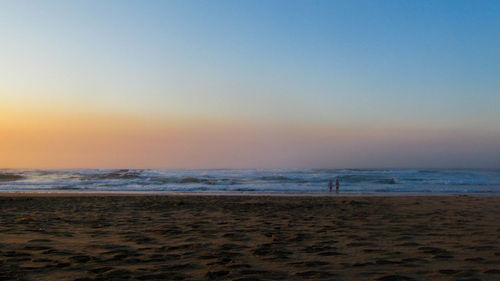 Scenic view of beach against sky during sunset