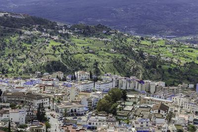 High angle view of townscape by sea against sky