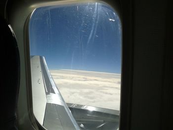 View of airplane wing seen through window