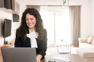 Portrait of smiling young woman using smart phone