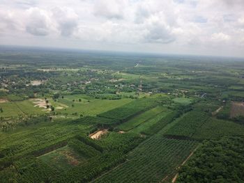 Scenic view of field against cloudy sky