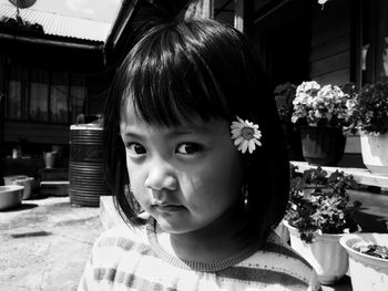 Close-up portrait of girl with pink flowers