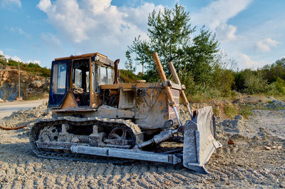 Abandoned truck on land against sky