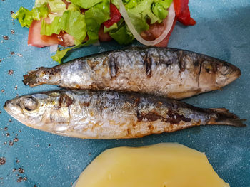 Top view of roasted sardine with salad and boiled potatoes. portugal typical cuisine