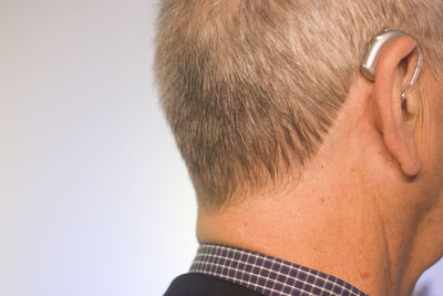 Close-up portrait of man against white background