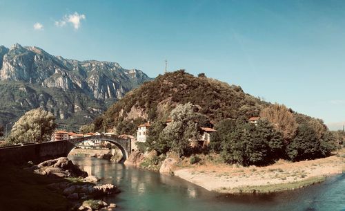 Arch bridge over river against sky