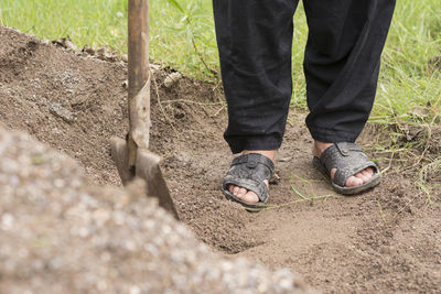 Low section of man standing on land