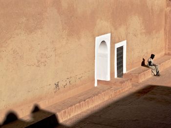 Man sitting outside taourirt kasbah in ouarzazate