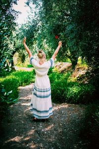 Full length of woman standing by tree