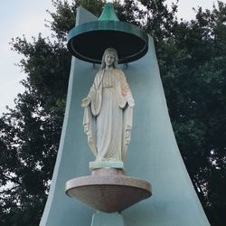 Low angle view of statue against trees