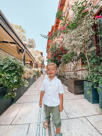 Full length of girl standing against plants