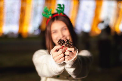 Portrait of woman holding plant