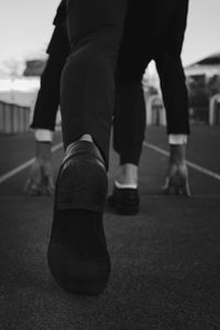 Low section of people walking on street