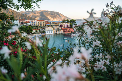 Scenic view of lake and buildings against sky