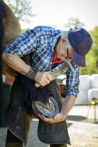 Man hammering horseshoe