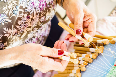 High angle view of woman holding threads