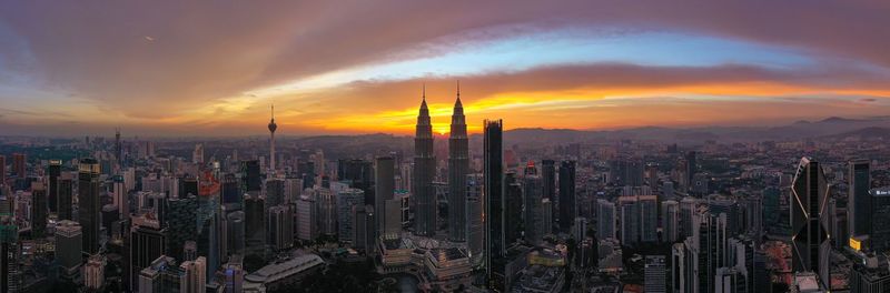 Aerial view of buildings in city during sunset