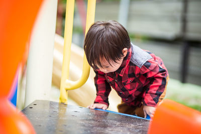 Rear view of boy looking at camera