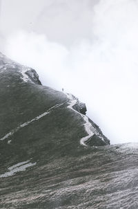 Scenic view of sea and mountain against sky