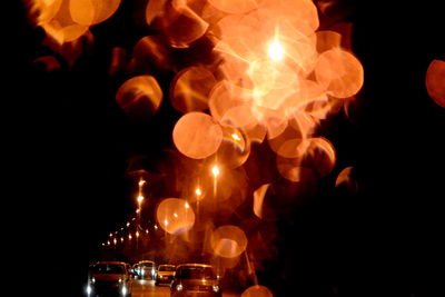 Close-up of lit candles on table