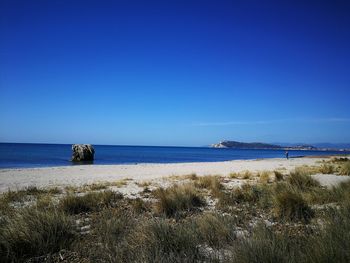 Scenic view of sea against clear blue sky