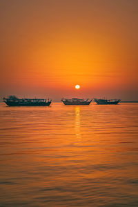 Scenic view of sea against orange sky