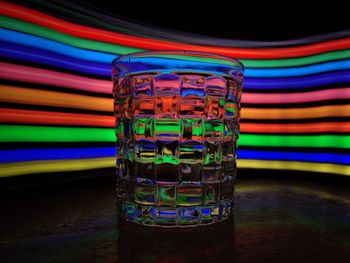 Close-up of multi colored glass on table