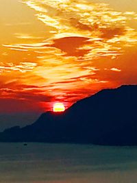 Scenic view of sea against romantic sky at sunset