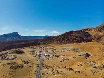 Scenic view of desert against blue sky