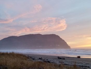 Scenic view of beach against sky during sunset