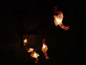 Close-up of lit candle in darkroom