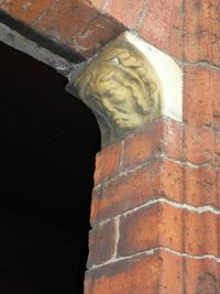 Low angle view of statue against wall