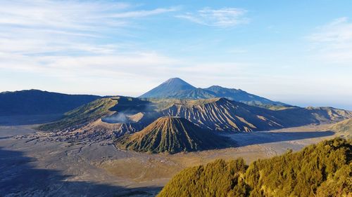 Scenic view of mountain range against cloudy sky