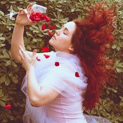 Side view of woman lying down on plant