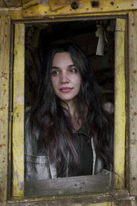 Portrait of young woman in abandoned room