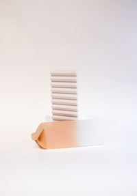 Close-up of stack of paper over white background