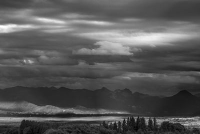 Scenic view of mountains against cloudy sky