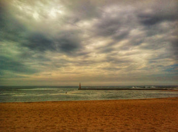 Scenic view of sea against cloudy sky