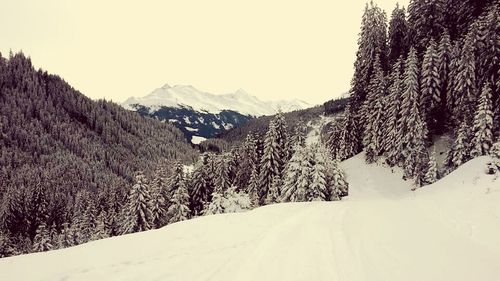Scenic view of snow covered mountains against clear sky