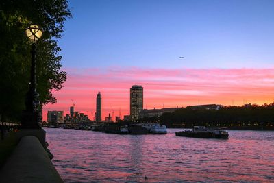 View of city at waterfront during sunset