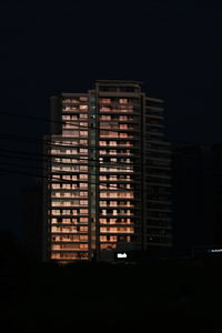 Illuminated building against sky at night