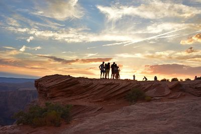 People standing on rocky landscape