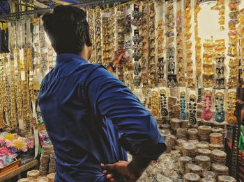 Rear view of man standing at market