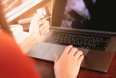 Midsection of person using mobile phone