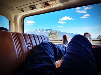 Low section of man sitting in bus